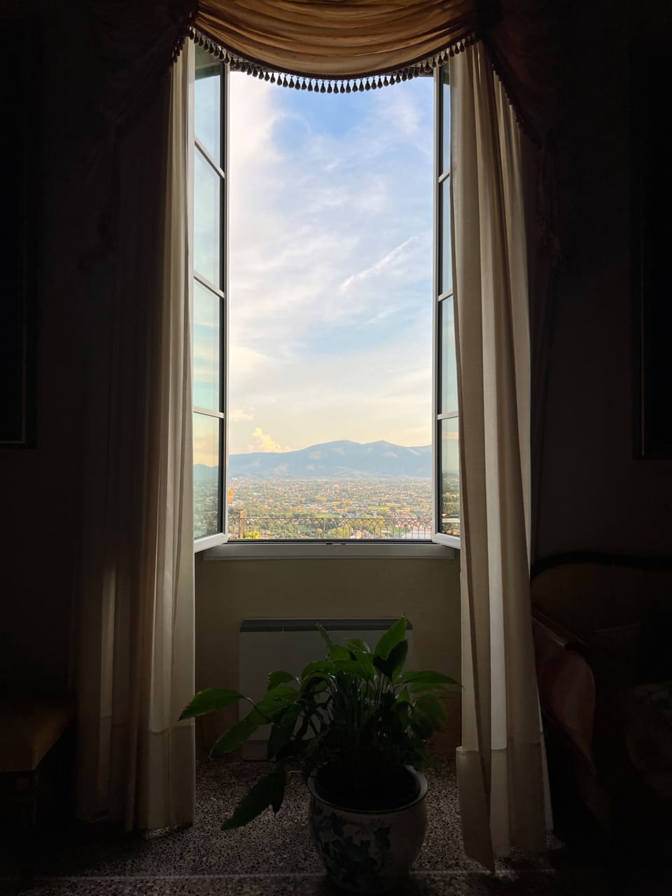 An open window of La Specola onto the plain of Lucca and the mountains